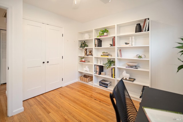 office area with light hardwood / wood-style floors and ceiling fan