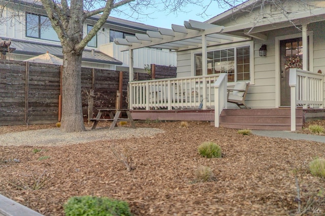 exterior space with a wooden deck and a pergola