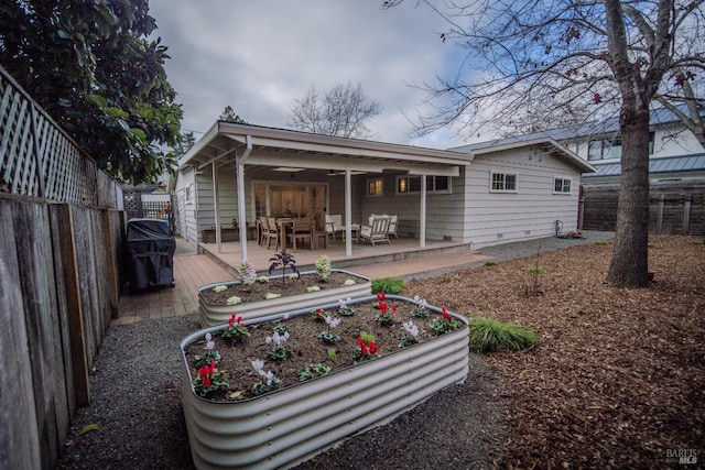 rear view of property with a wooden deck