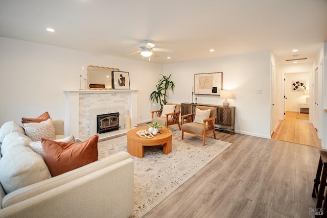 living room featuring ceiling fan and light wood-type flooring