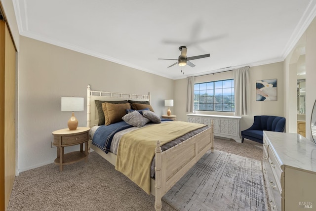 carpeted bedroom featuring crown molding, ceiling fan, and a closet