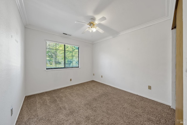 empty room featuring crown molding, carpet floors, and ceiling fan