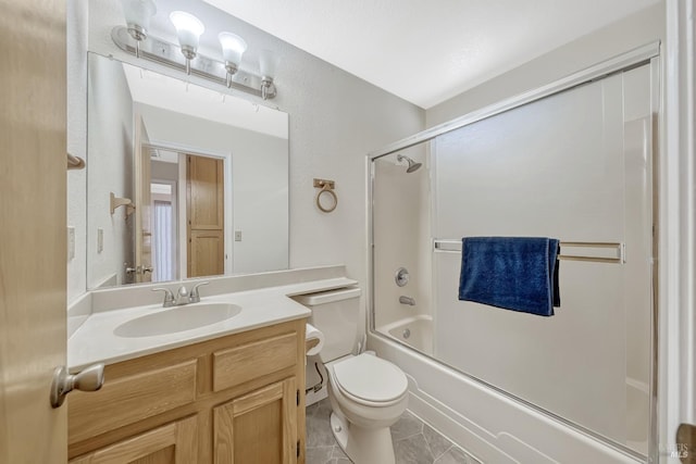 full bathroom featuring tile patterned floors, vanity, toilet, and combined bath / shower with glass door