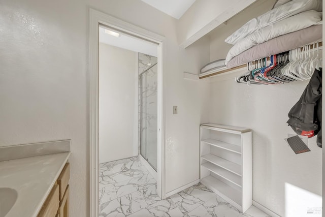 bathroom with vanity and a shower with shower door