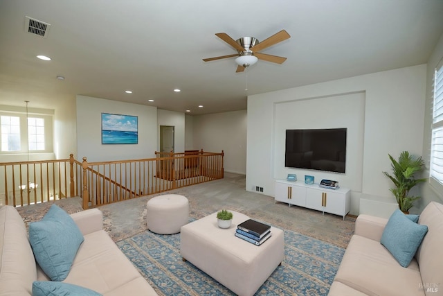 living room with carpet flooring, visible vents, and recessed lighting