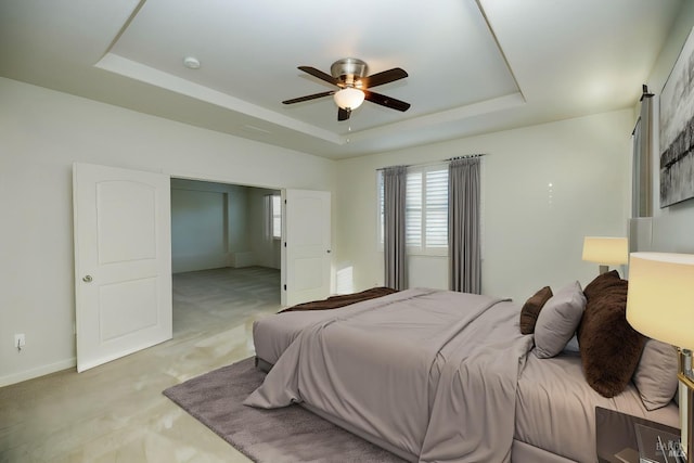 bedroom with light carpet, a raised ceiling, and ceiling fan