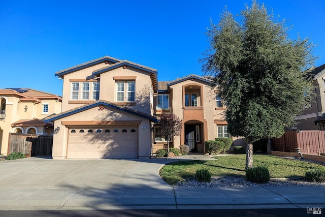 view of front of home with driveway, a tile roof, fence, and stucco siding