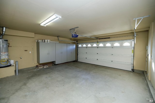 garage featuring secured water heater and a garage door opener