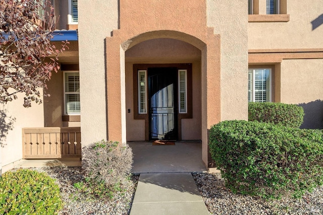 entrance to property with stucco siding