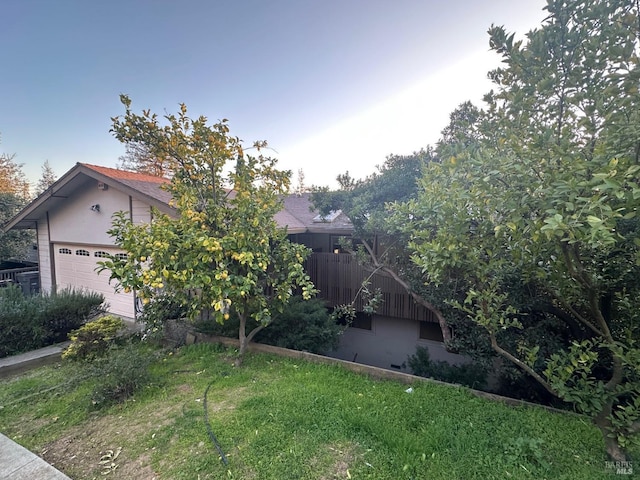 view of front of house featuring a garage and a front lawn