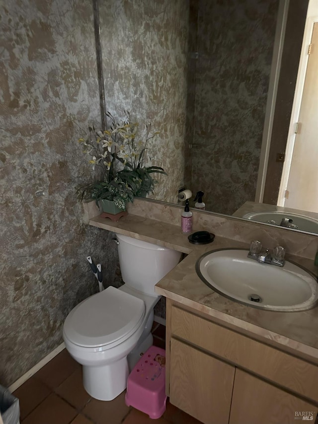 bathroom featuring vanity, toilet, and tile patterned flooring