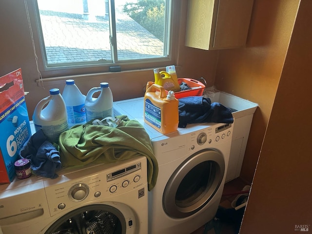 clothes washing area with washer and clothes dryer