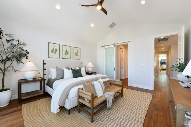 bedroom featuring hardwood / wood-style floors, high vaulted ceiling, a barn door, and ceiling fan