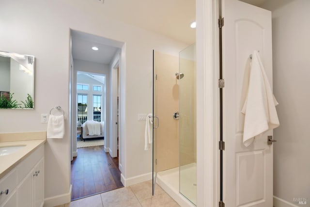 bathroom featuring tile patterned floors, vanity, and an enclosed shower