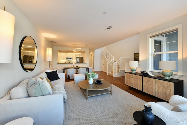 living room with dark hardwood / wood-style flooring