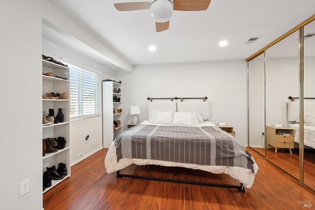 bedroom featuring ceiling fan, wood-type flooring, and a closet