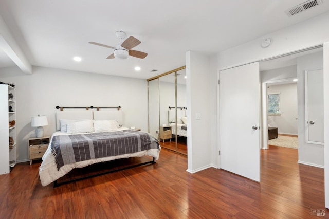 bedroom with hardwood / wood-style flooring, a closet, and ceiling fan