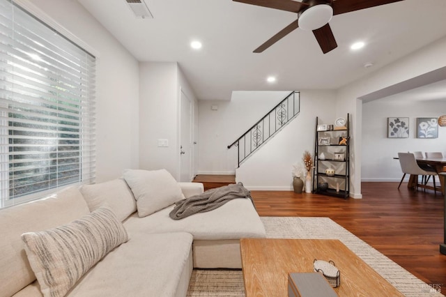 living room with dark wood-type flooring and ceiling fan