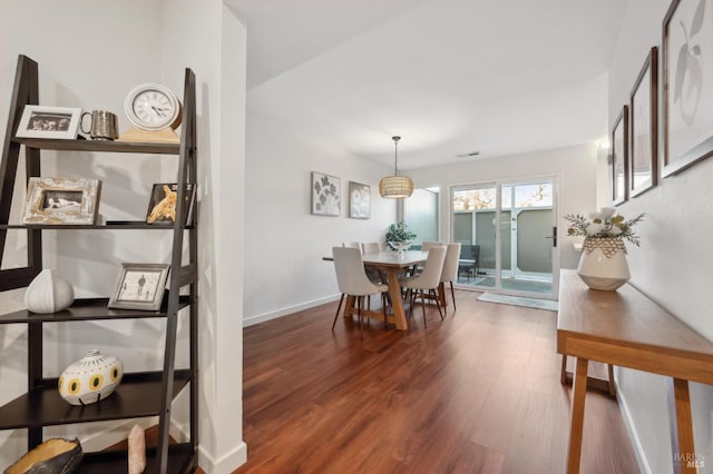 dining space with dark wood-type flooring