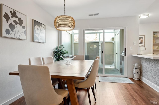 dining area with plenty of natural light and dark hardwood / wood-style floors