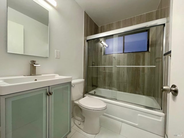 full bathroom with vanity, shower / bath combination with glass door, toilet, and tile patterned flooring