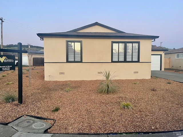 view of side of property with a garage