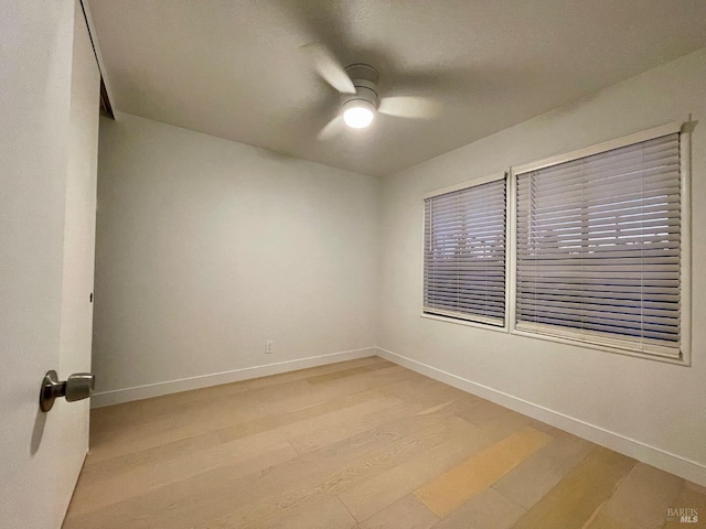 unfurnished room with ceiling fan and light wood-type flooring