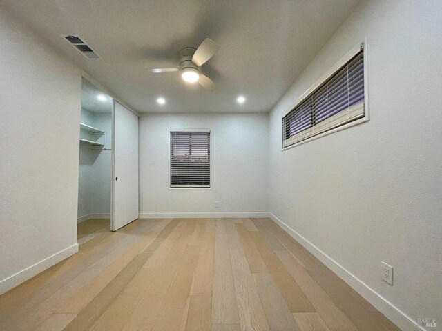 spare room featuring ceiling fan and light wood-type flooring