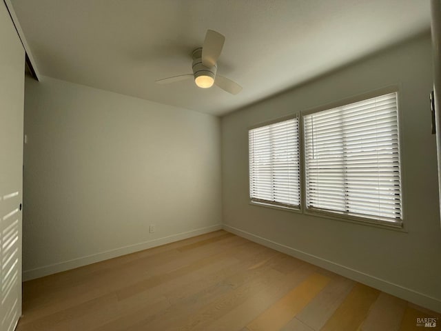 spare room with light hardwood / wood-style flooring and ceiling fan