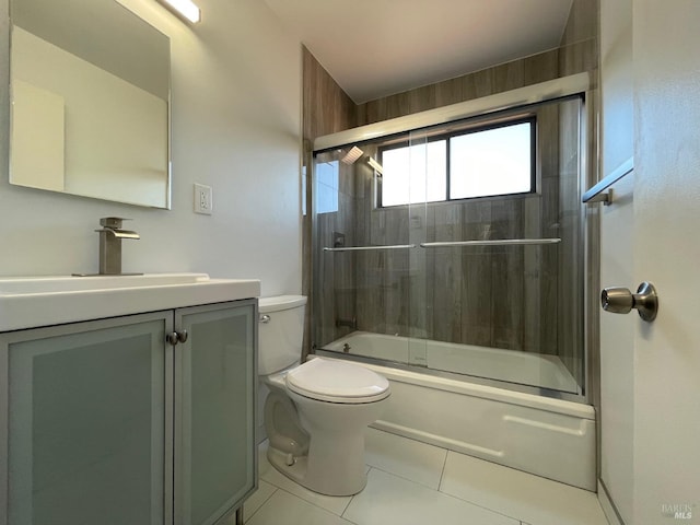 full bathroom featuring enclosed tub / shower combo, vanity, toilet, and tile patterned floors