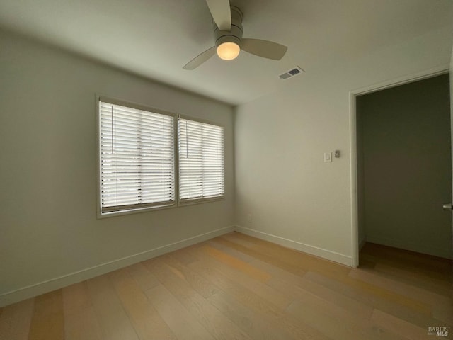 unfurnished room featuring light hardwood / wood-style flooring and ceiling fan