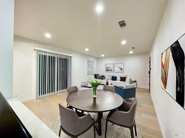 dining area with light hardwood / wood-style floors