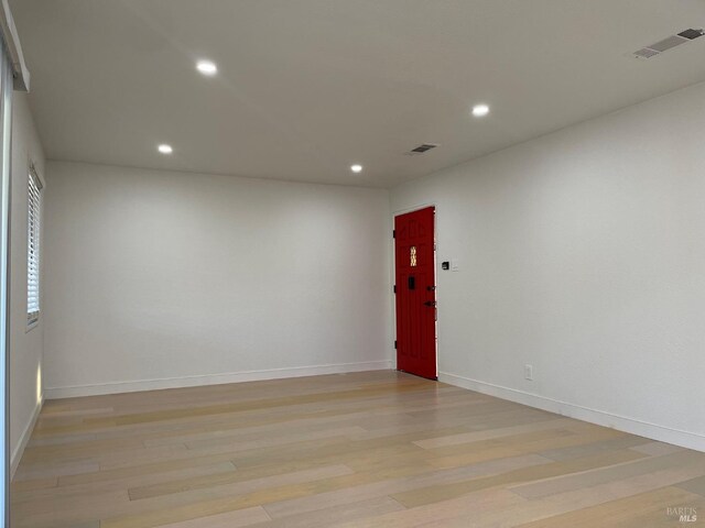 empty room with light hardwood / wood-style flooring