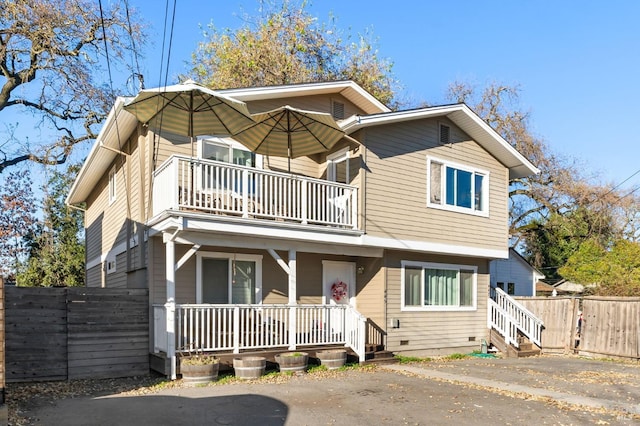 view of front of house featuring a porch and a balcony