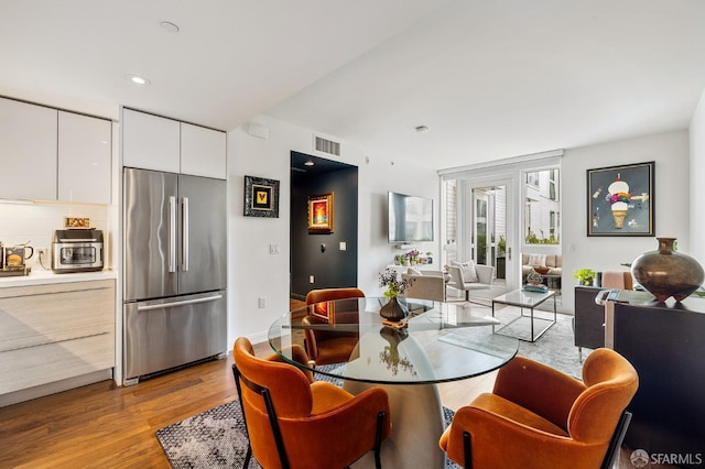 dining space featuring light wood-type flooring