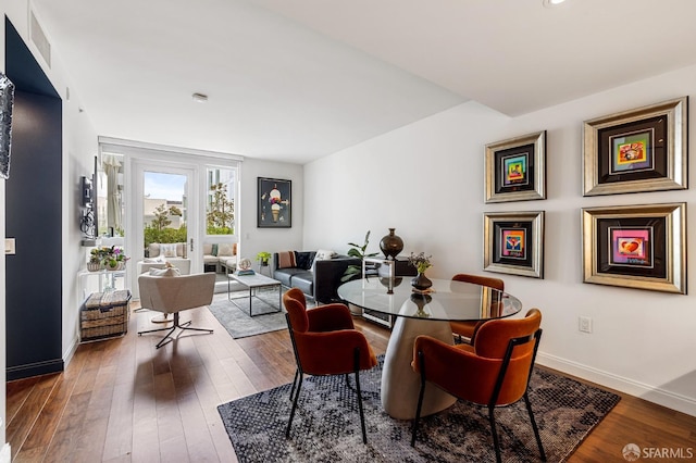 dining area featuring dark wood-type flooring