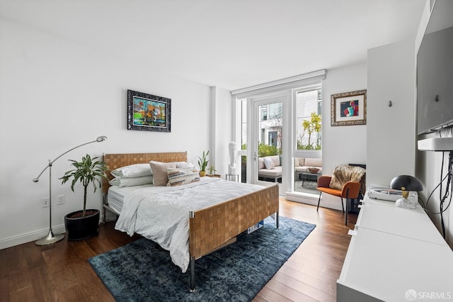 bedroom with dark hardwood / wood-style flooring and access to exterior