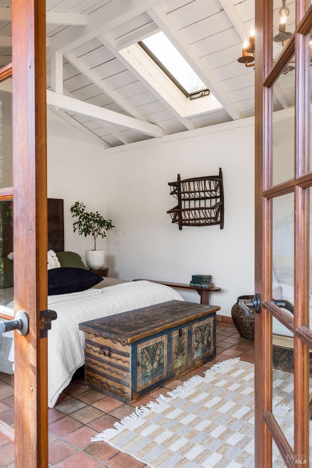 bedroom featuring vaulted ceiling with skylight, tile patterned flooring, and wooden ceiling