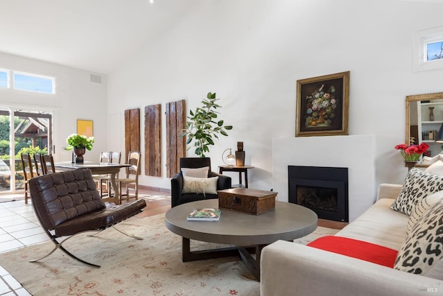 living room with a high ceiling and light tile patterned floors