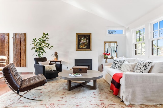 living room featuring lofted ceiling and light tile patterned floors