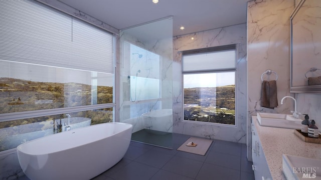 bathroom with vanity, a bath, tile patterned flooring, and tile walls