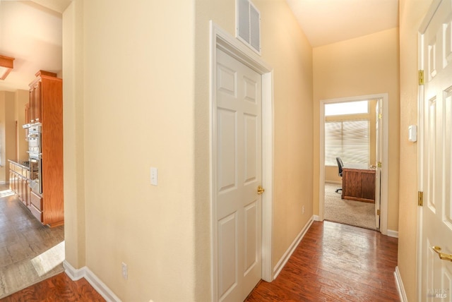 hallway with dark wood-type flooring