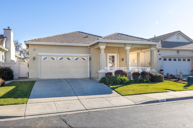 ranch-style home with a garage, covered porch, and a front lawn