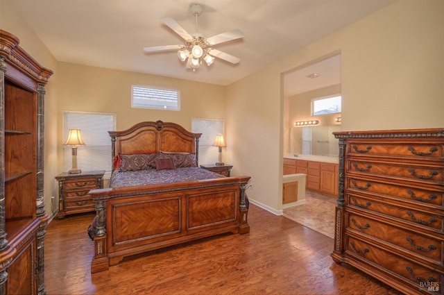 bedroom featuring ensuite bathroom, dark hardwood / wood-style floors, and ceiling fan