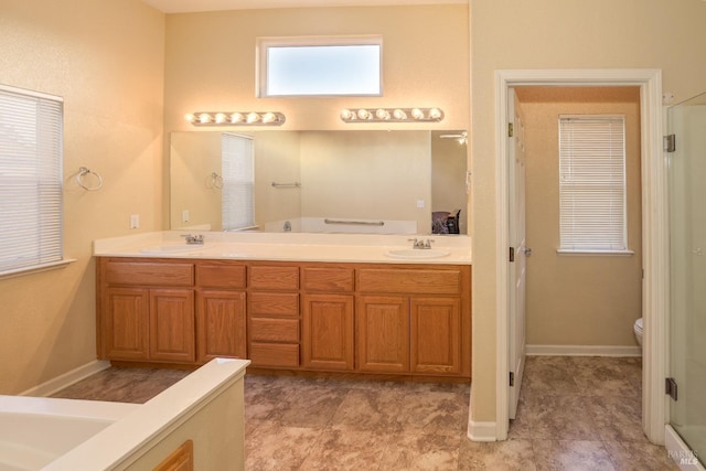 bathroom with vanity, an enclosed shower, and toilet