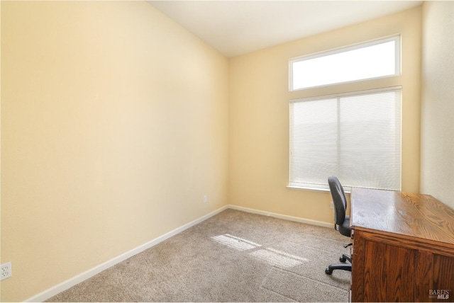 unfurnished office featuring light colored carpet