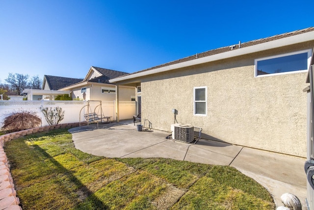 rear view of house featuring a lawn, a patio, and central air condition unit