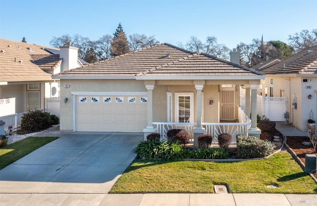 view of front facade featuring a porch, a garage, and a front yard