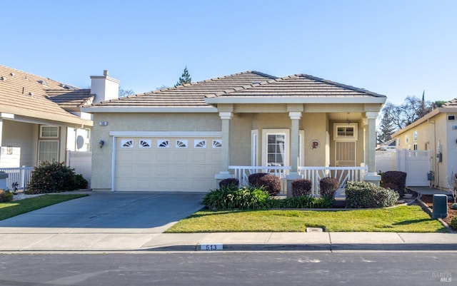 view of front facade featuring a garage, a front yard, and covered porch