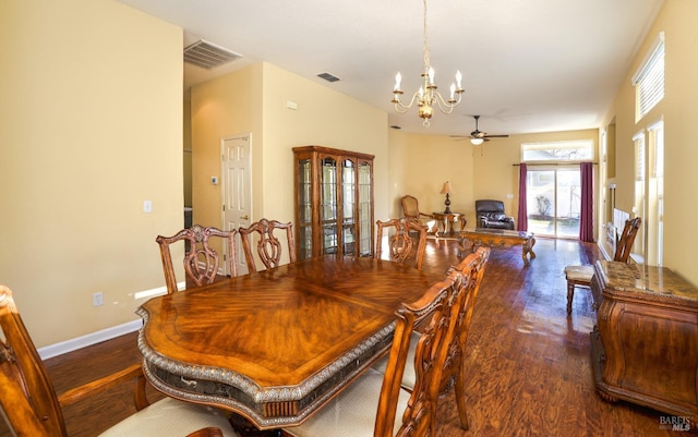 dining space with dark hardwood / wood-style floors and ceiling fan with notable chandelier